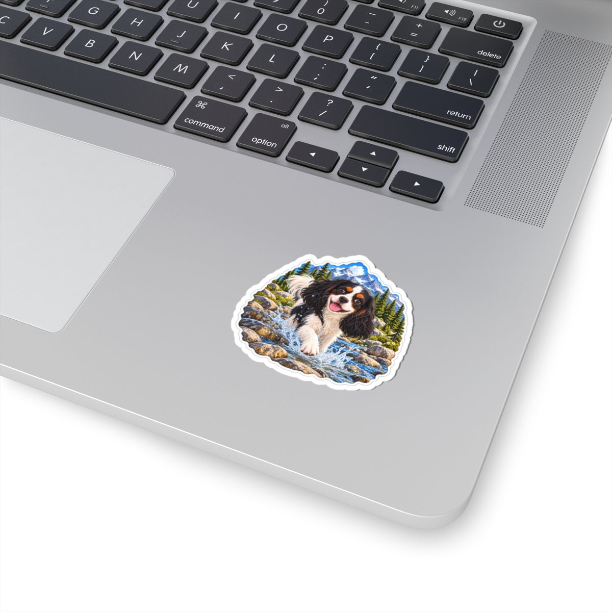 Cavy Play Mode mountain river sticker featuring Rowan, a tricolor Cavalier King Charles Spaniel, shown in a product mockup.