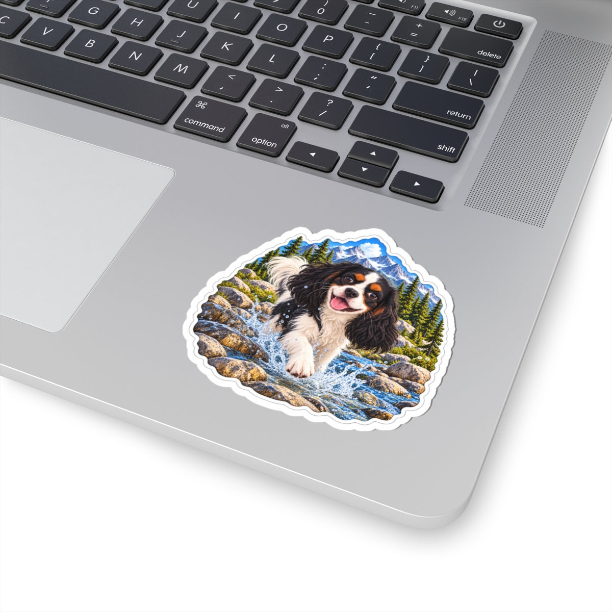 Cavy Play Mode mountain river sticker featuring Rowan, a tricolor Cavalier King Charles Spaniel, shown in a product mockup.