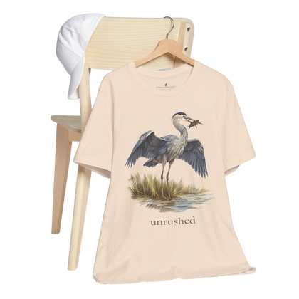 Great blue heron standing in shallow water with wings open on the Val T-shirt