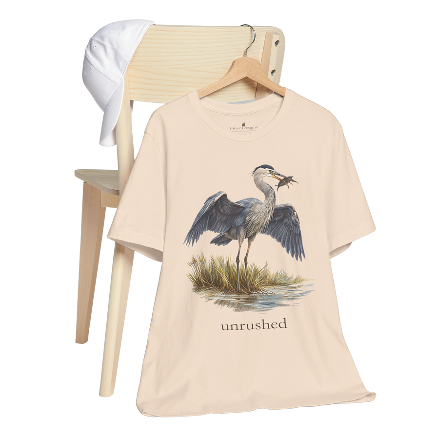 Great blue heron standing in shallow water with wings open on the Val T-shirt