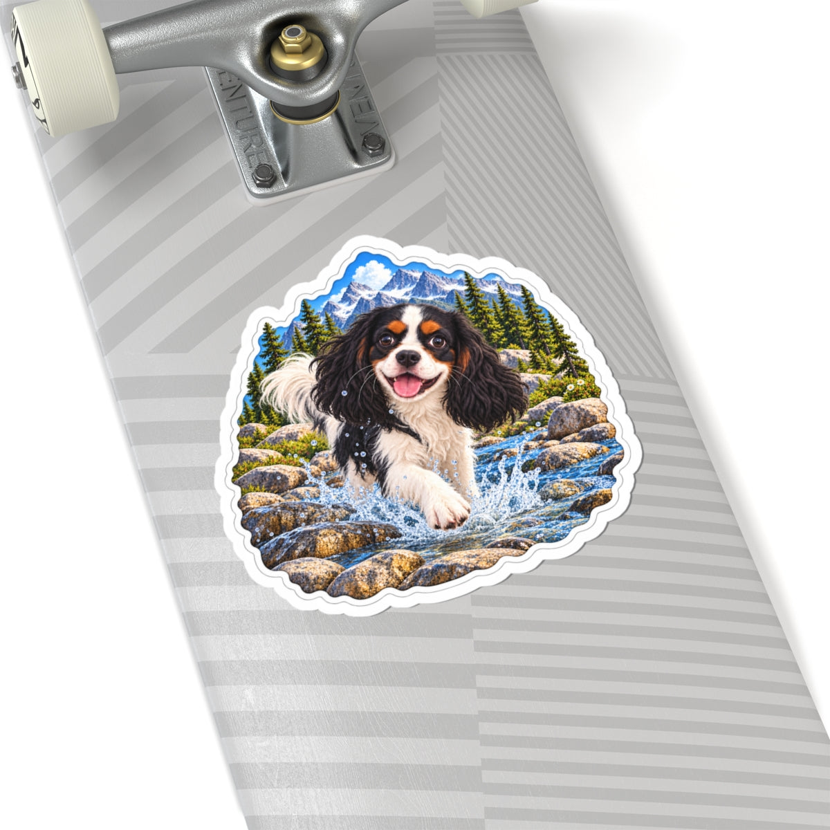 Cavy Play Mode mountain river sticker featuring Rowan, a tricolor Cavalier King Charles Spaniel, shown in a product mockup.